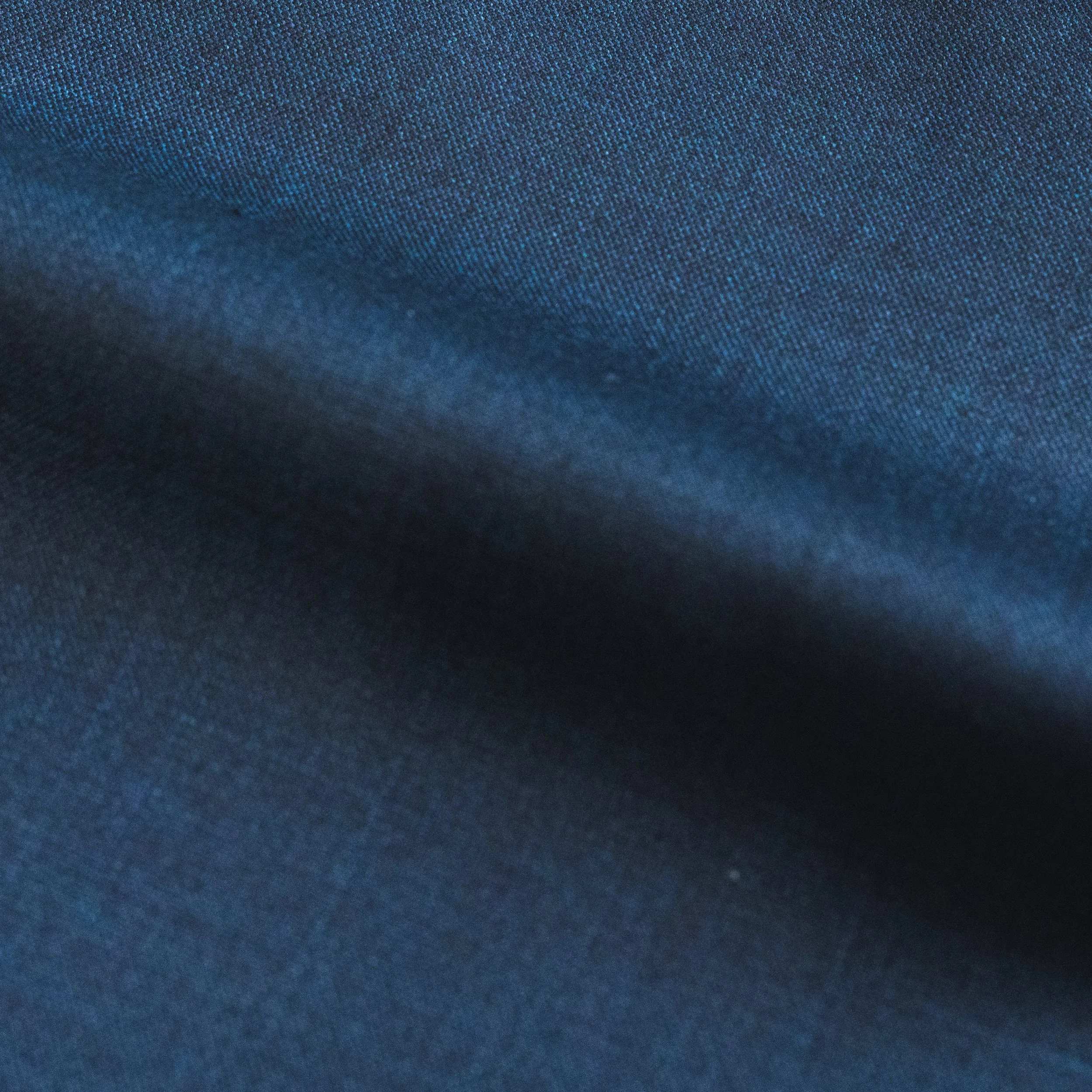 Close-up of a dark blue textured fabric surface.