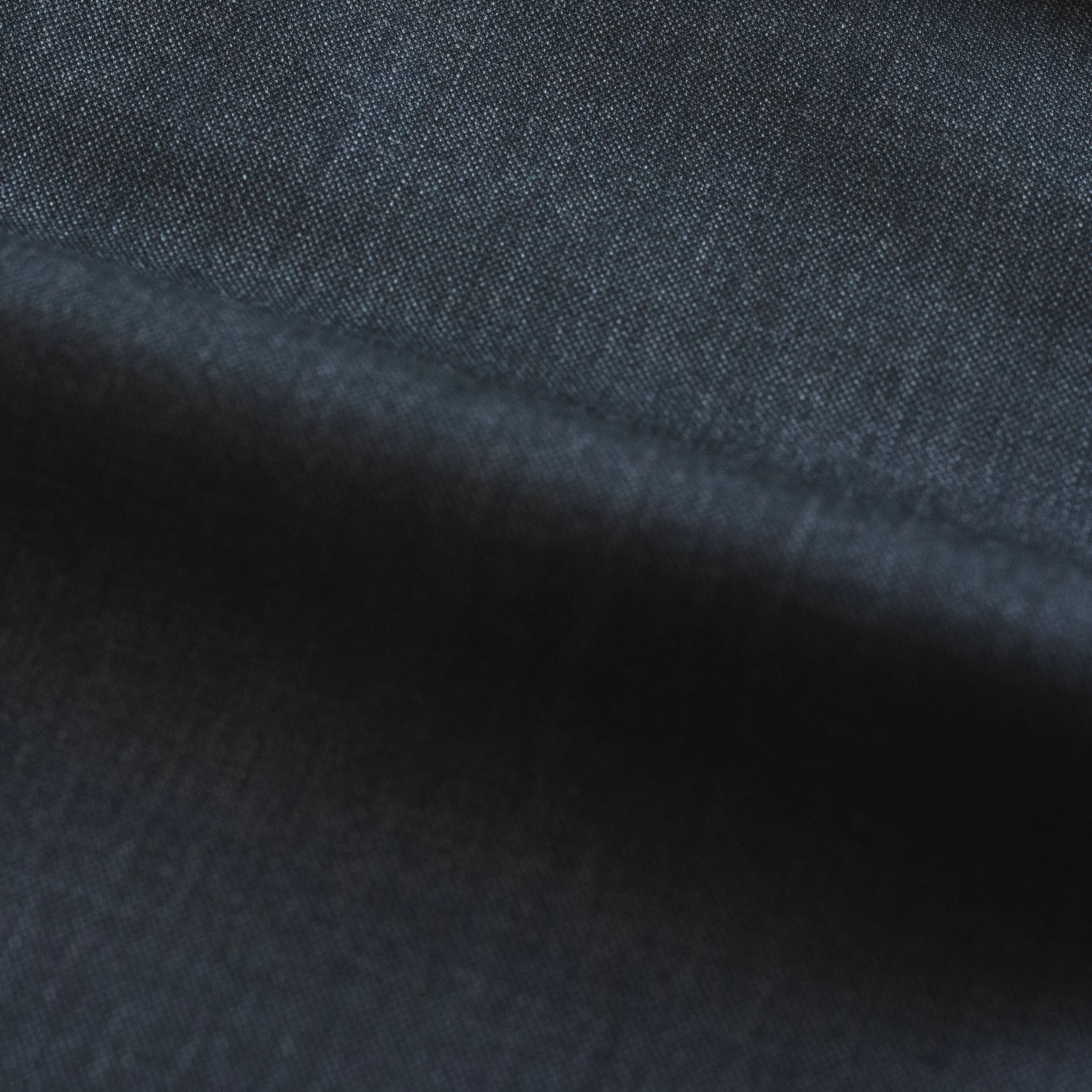 A close-up of a dark suit fabric.