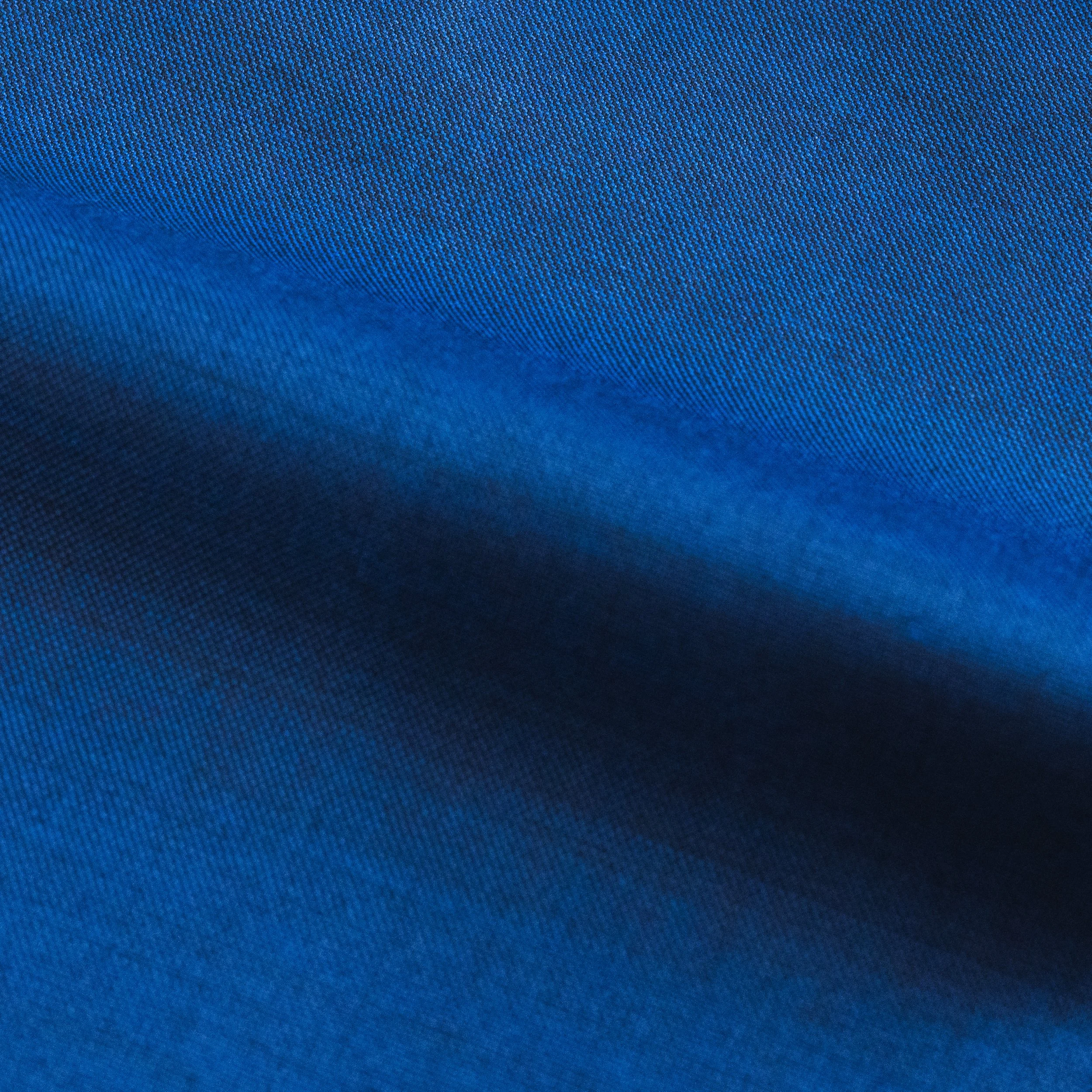 Close-up of textured blue fabric with fine woven pattern.
