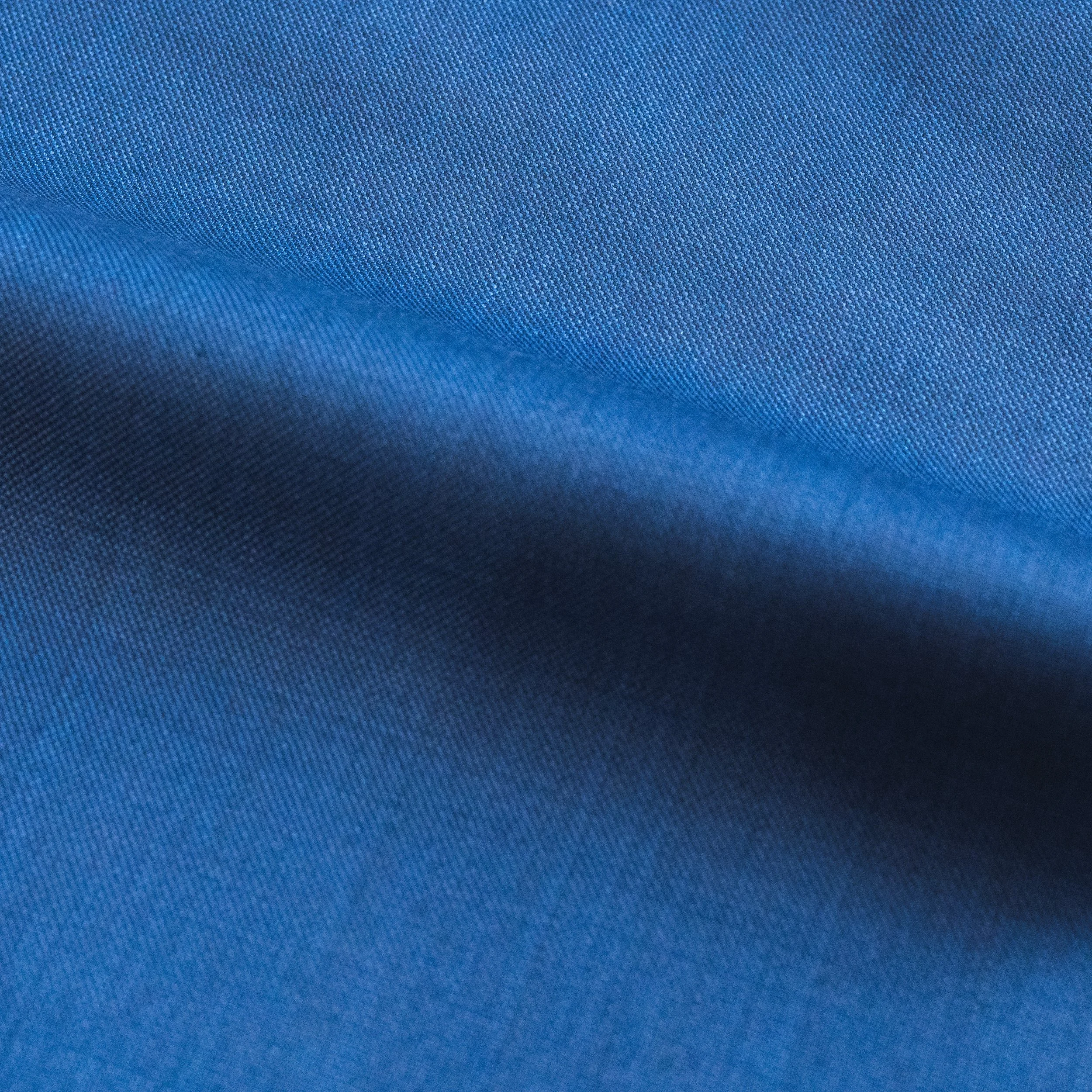 Close-up of blue fabric with a textured pattern.