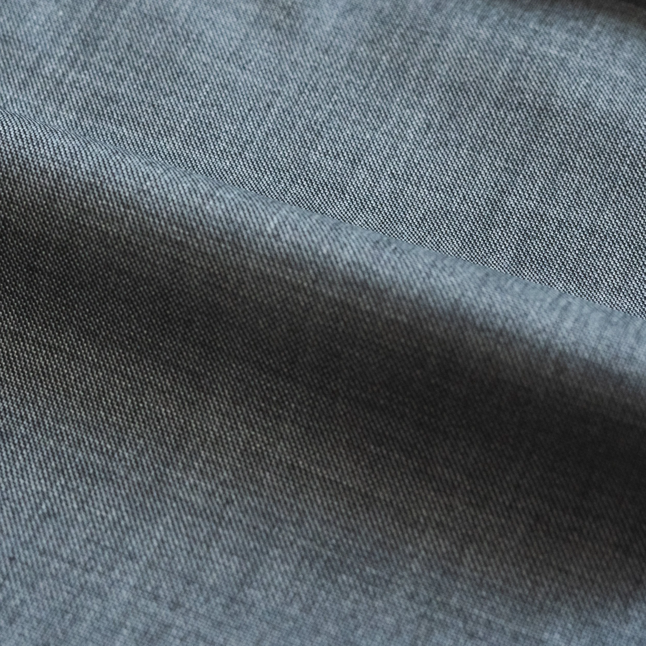 Close-up view of a gray fabric with a tight, patterned weave.
