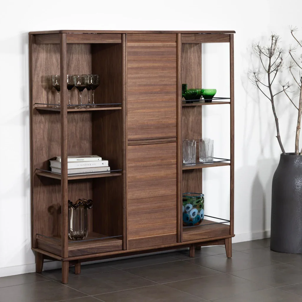 A wooden shelving unit and home bar with rotating doors by Skovby