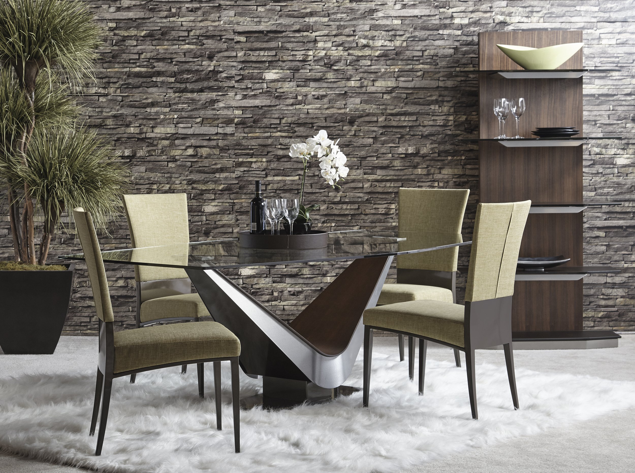 Contemporary dining room with a glass table and four beige upholstered chairs with high backs by Elite Moden furniture.