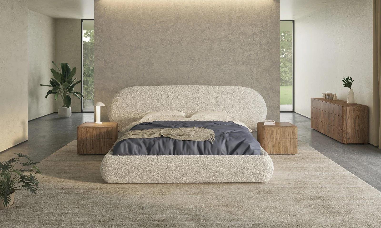 Modern bedroom with a textured white bed, wooden nightstands, a beige accent wall, large windows with greenery outside, and minimalistic decor.