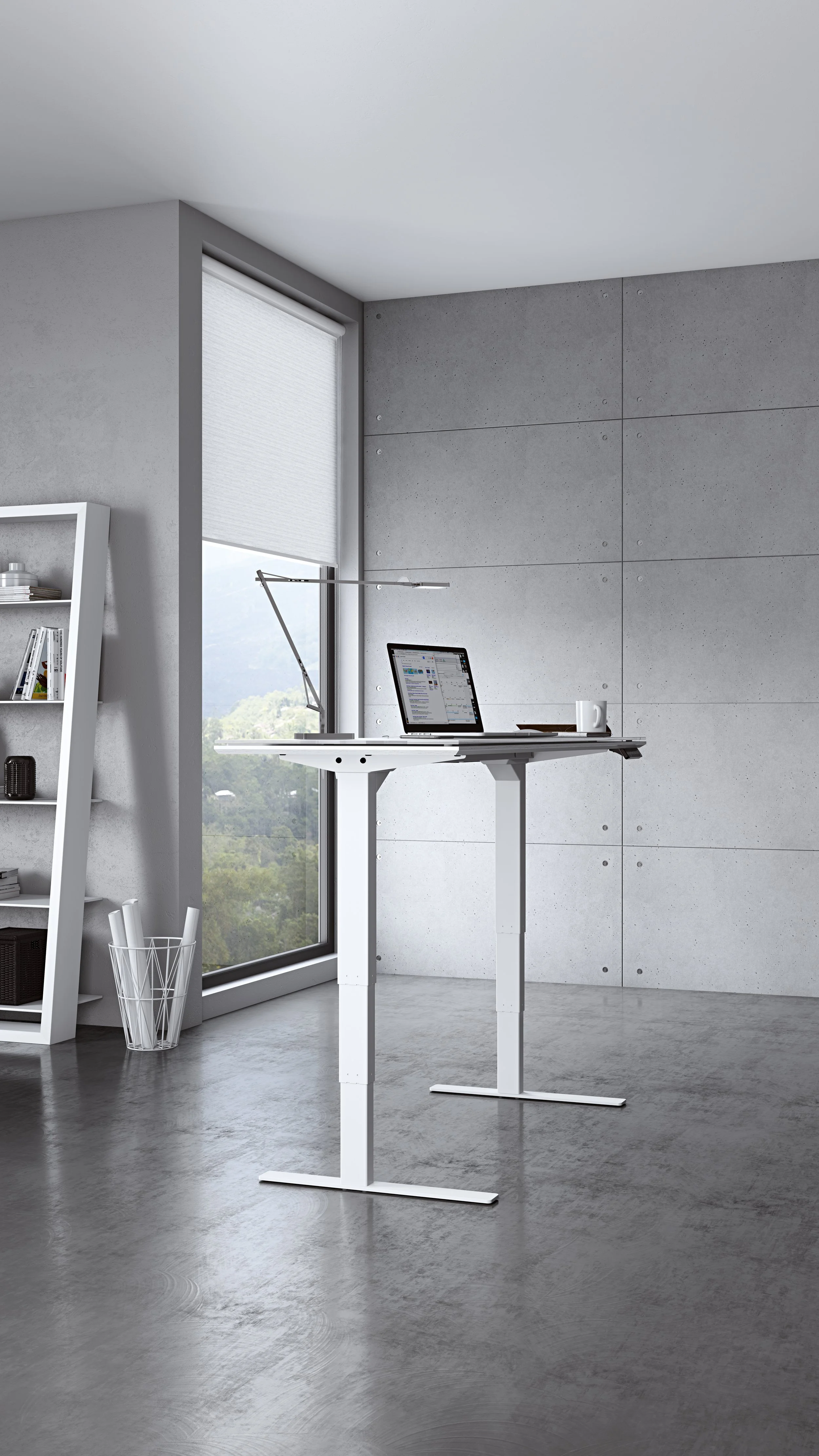 Modern home office with a adjustable white desk, a laptop, a white coffee mug, and a large window with a view of trees and mountains.