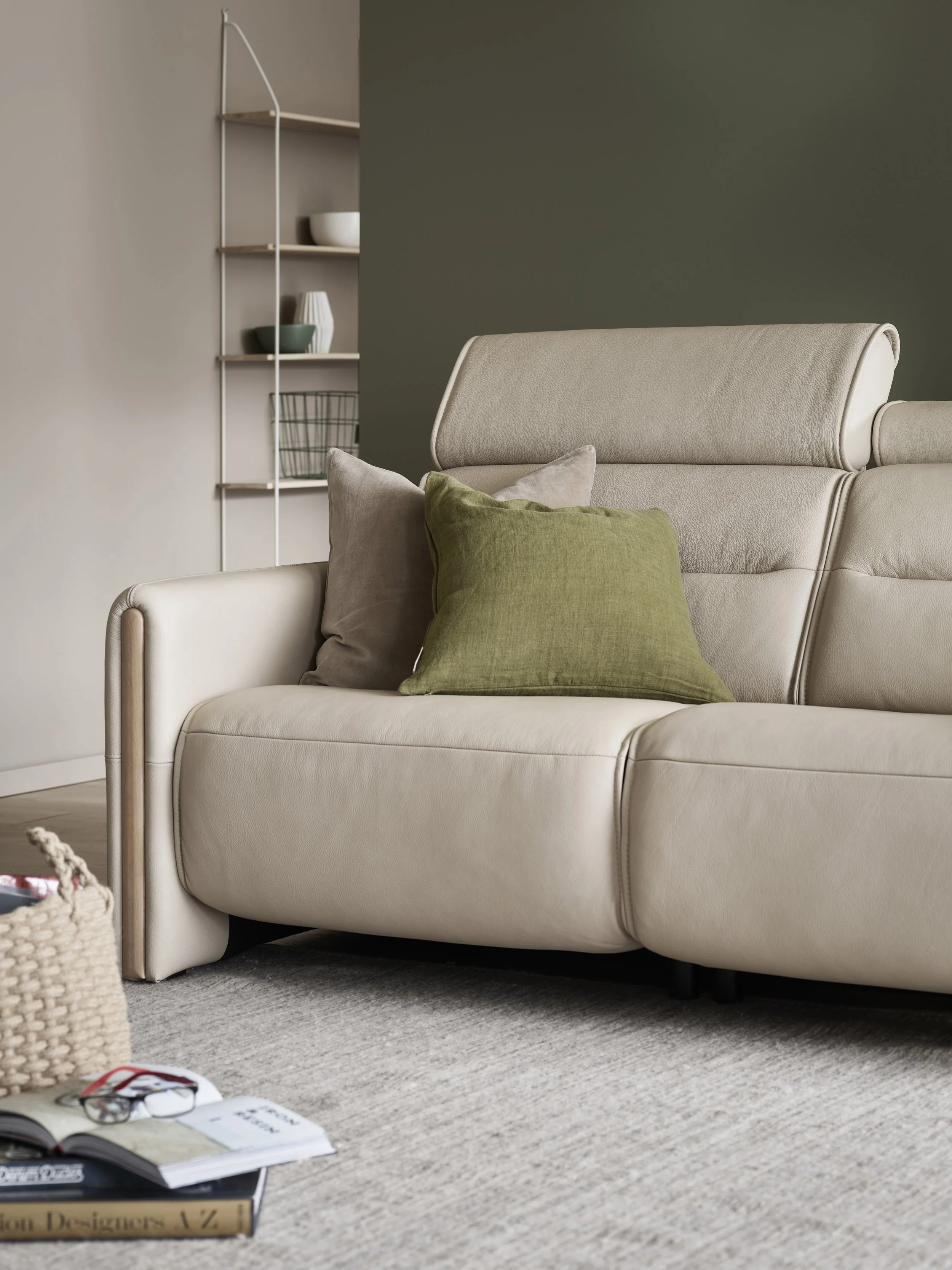 A beige leather sofa with adjustable headrests by Stressless in a modern living room
