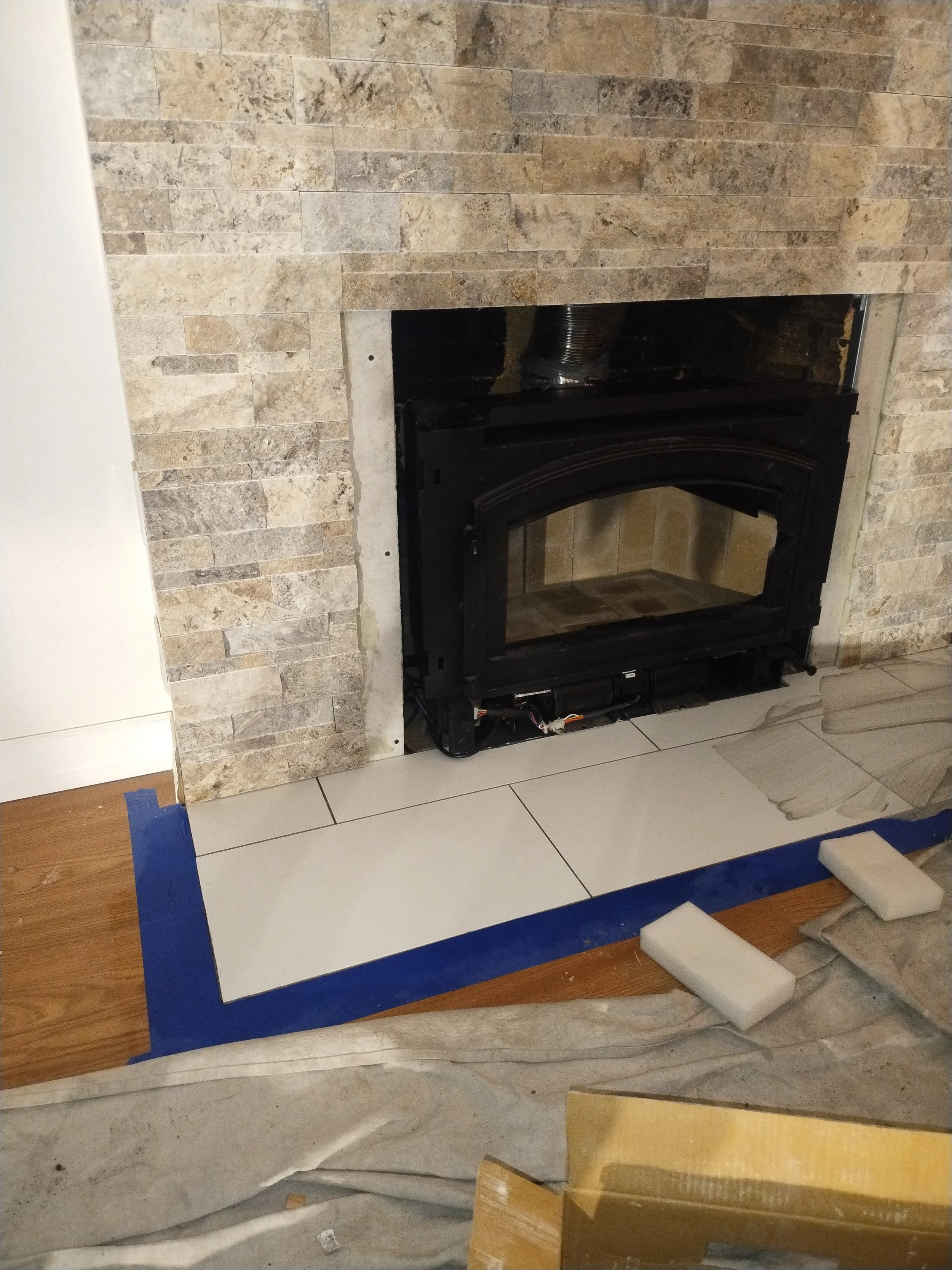 Stone, Tile and a Woodstove insert installation for the fireplace