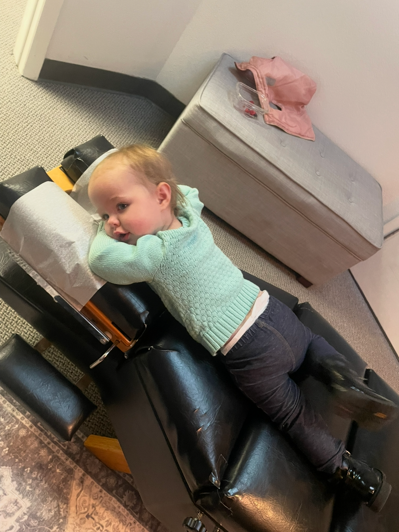 Toddler on relaxed on chiropractic table