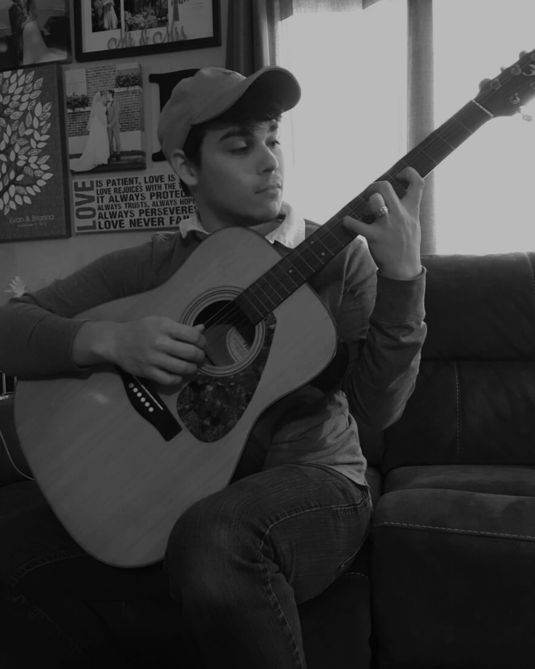 guy playing a guitar on a couch