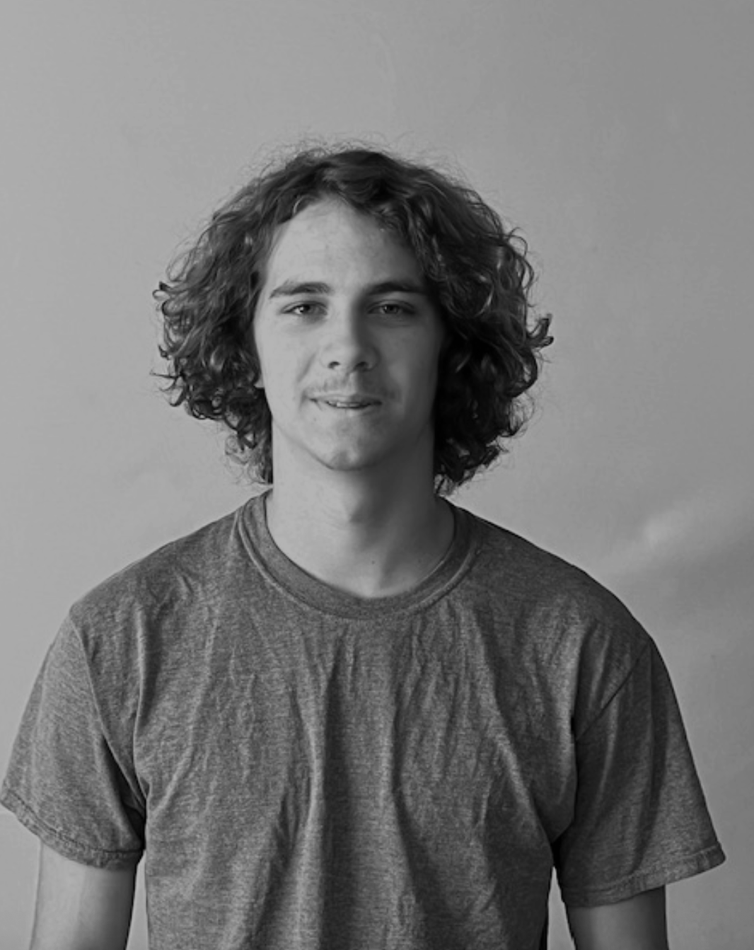 guy with curly hair posing
