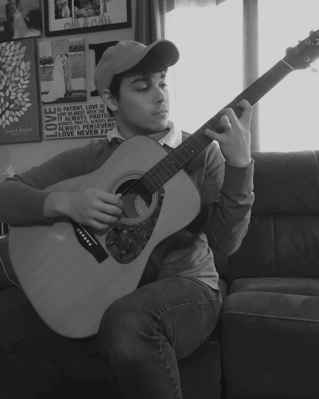 guy playing guitar on a couch