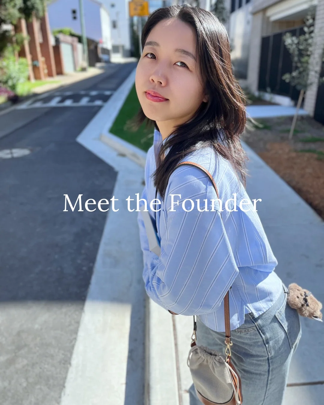 Young Asian woman wearing a light blue striped shirt and crossbody bag, standing outdoors on a sunlit suburban street — Meet the Founder of Chulip