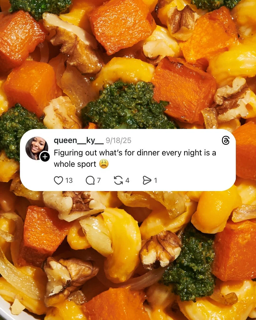 Close-up of a plate of roasted vegetables including butternut squash, carrots, broccoli, walnuts, and onions.