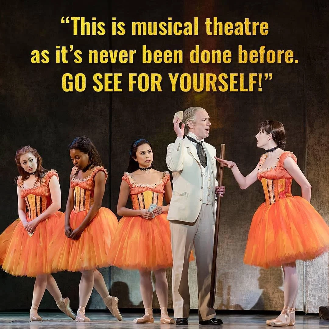 Actors on stage in ballet costumes with a quote about musical theater displayed above. The quote says, 'This is musical theater as it's never been done before. GO SEE FOR YOURSELF!'