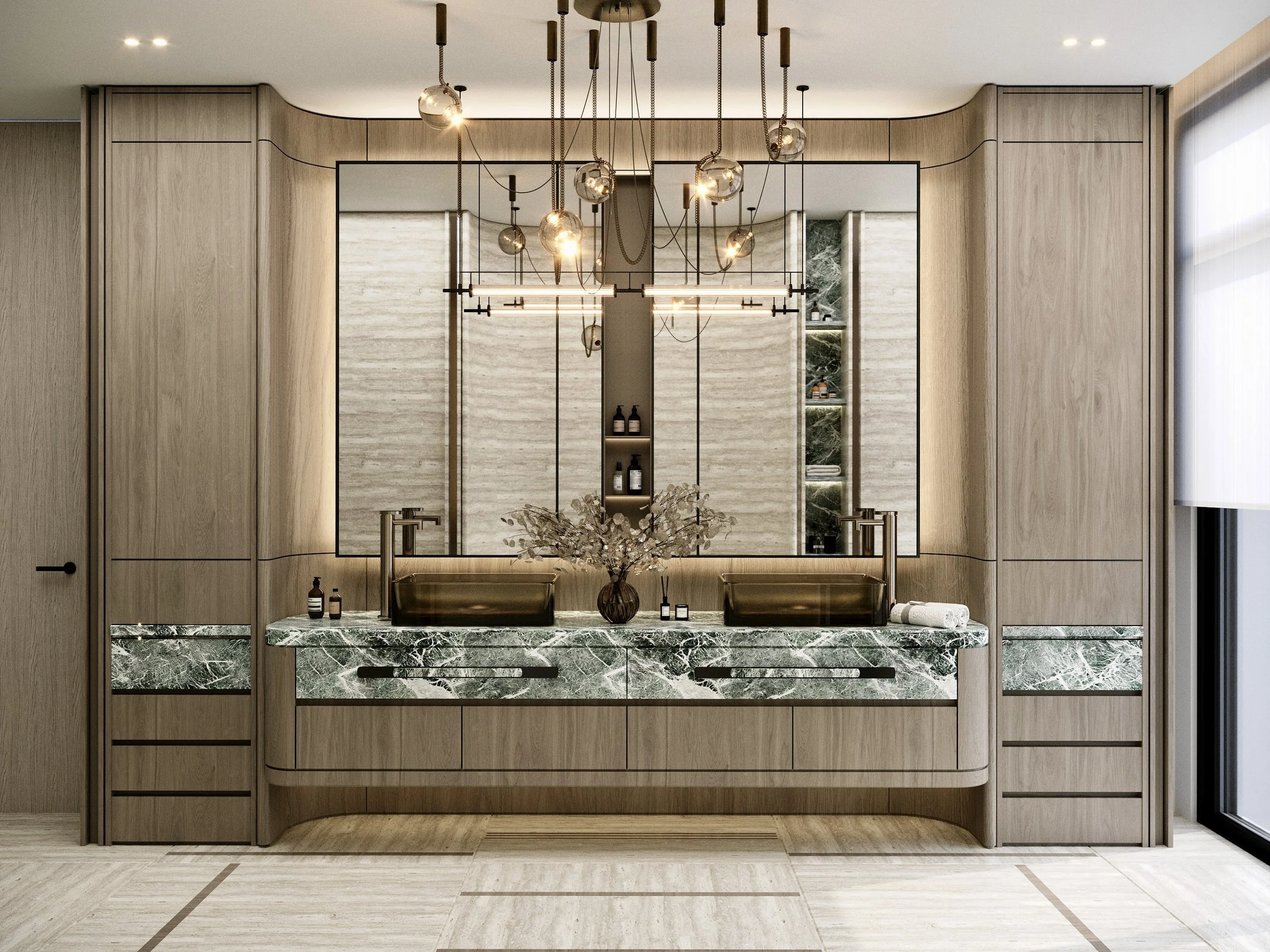A modern bathroom with a floating vanity made of dark green marble, a large mirror, wooden cabinetry, a comfortable tufted bench, and decorative pendant lighting fixtures.