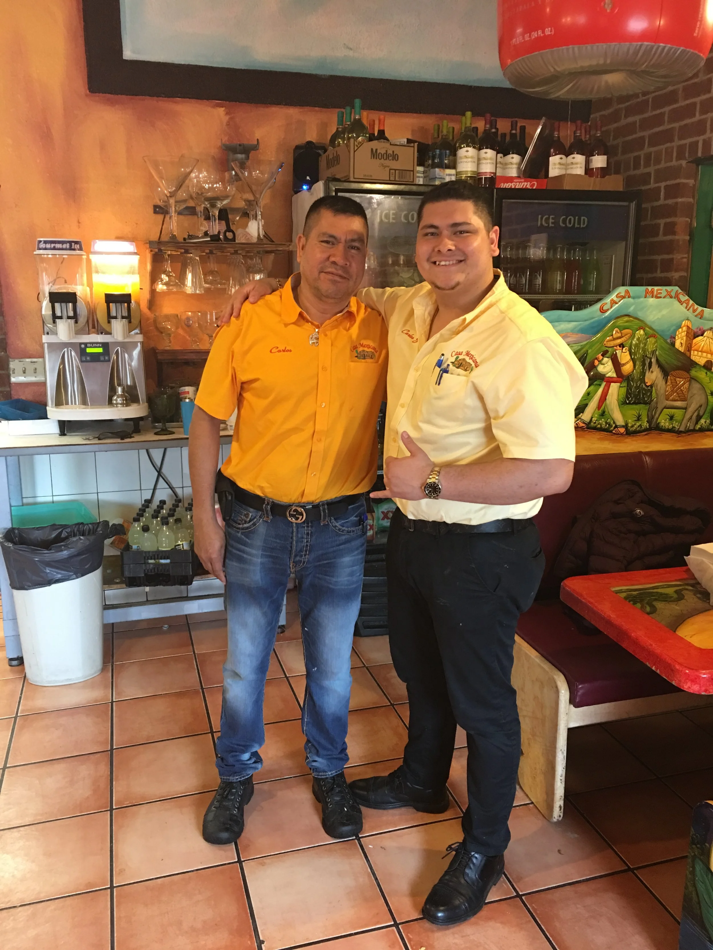 Carlos Jacinto and Carlos Jacinto Jr. standing together inside Casa Mexicana. Pioneering our family friendly atmosphere, authentic family recipes, and a vacation vibe that is second to none. Enjoy our burritos, tacos, margaritas, and so much more!