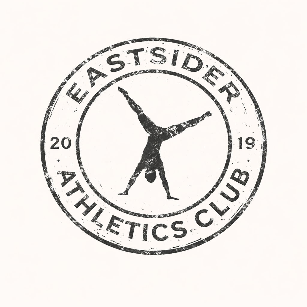 A circular logo for Eastside Athletics Club featuring a gymnast performing a handstand with legs extended outward, surrounded by the text 'Eastside Athletics Club' and the year '2019' on a distressed black and white background.