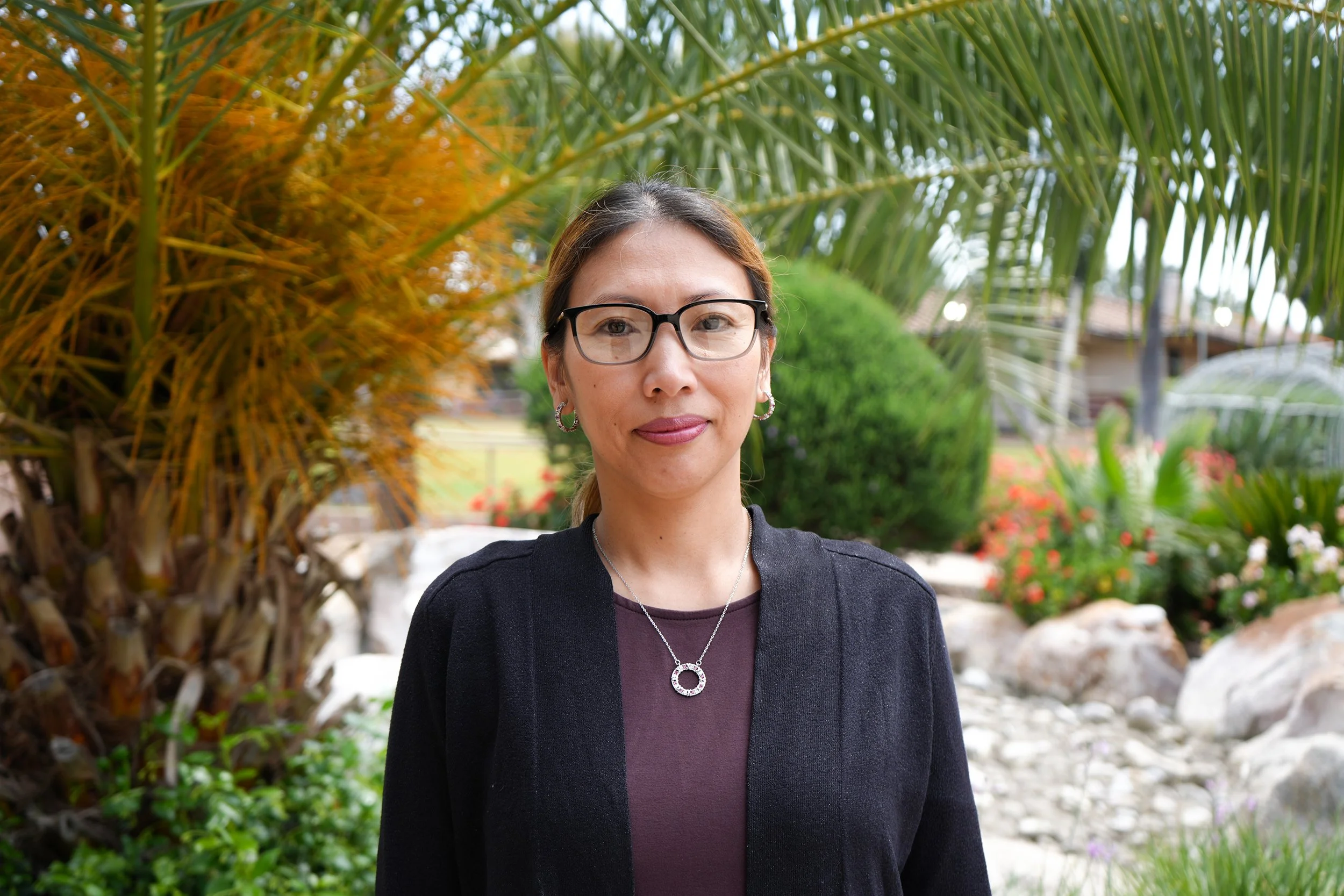 Logo of Ark Angel Foundation including angel with wings holding house, with company name in black text, against a background of purple and white pattern.