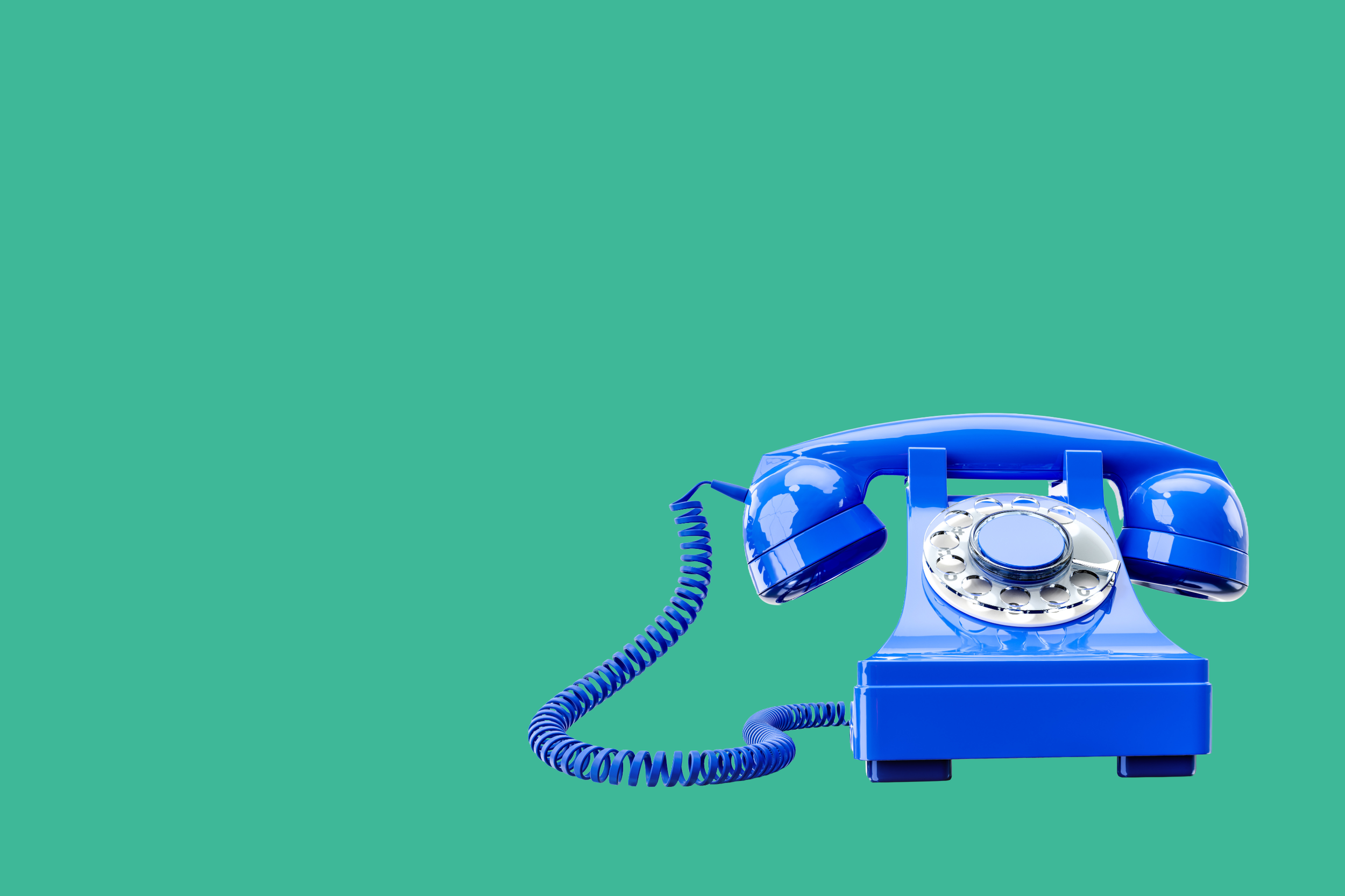 Blue vintage rotary telephone on a green background.