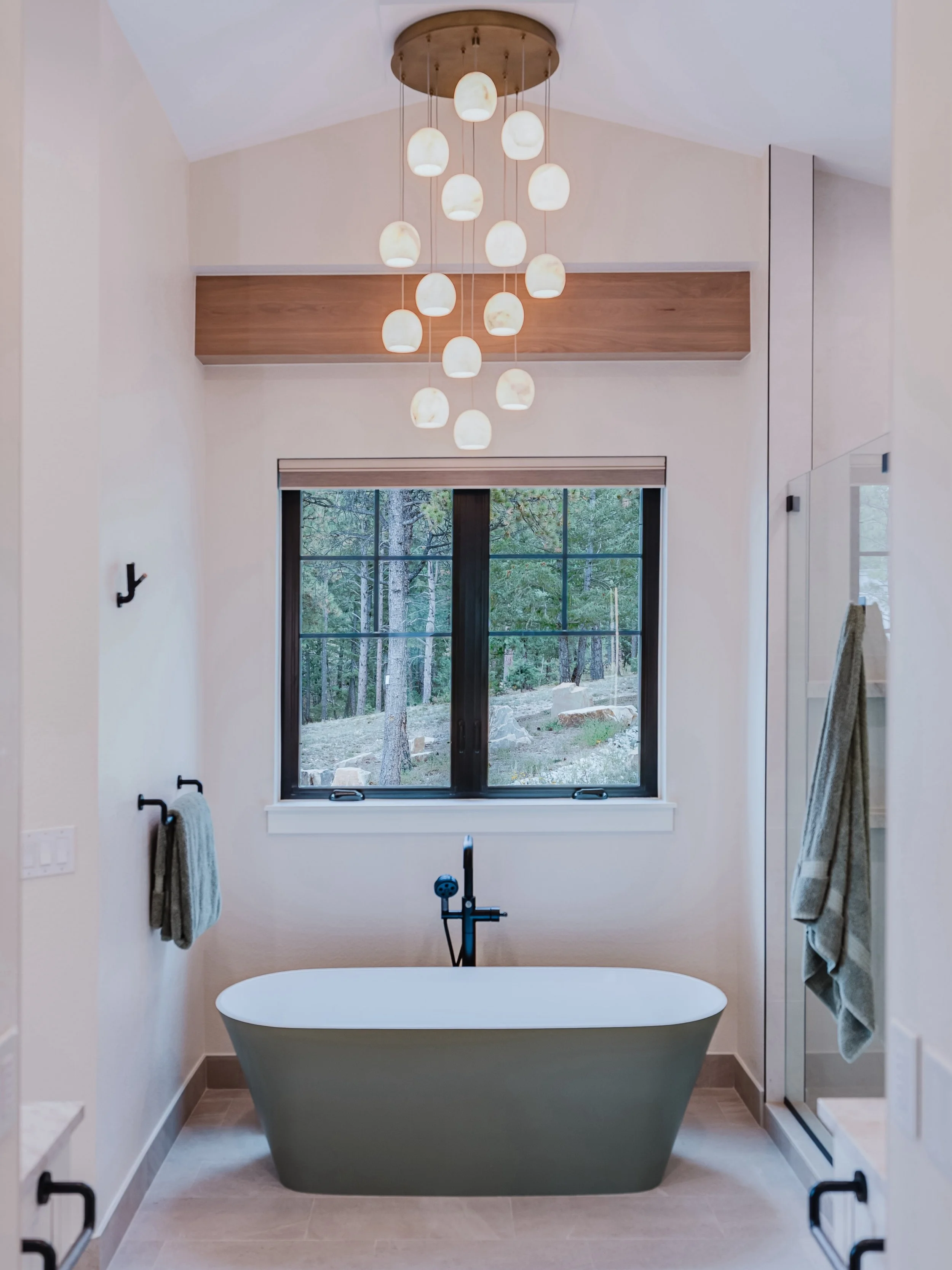 A quiet retreat with a view. 🛁🌲

This primary bathroom brings together warm natural materials, clean modern lines, and the beauty of the Colorado landscape just outside the window.

From the sculptural freestanding tub and custom wood accents to th