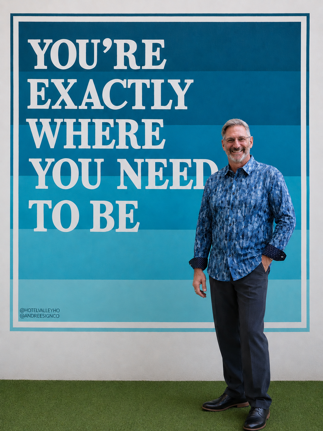Daniel standing in front of inspirational mural at the Vally-Ho Hotel in Phoenix