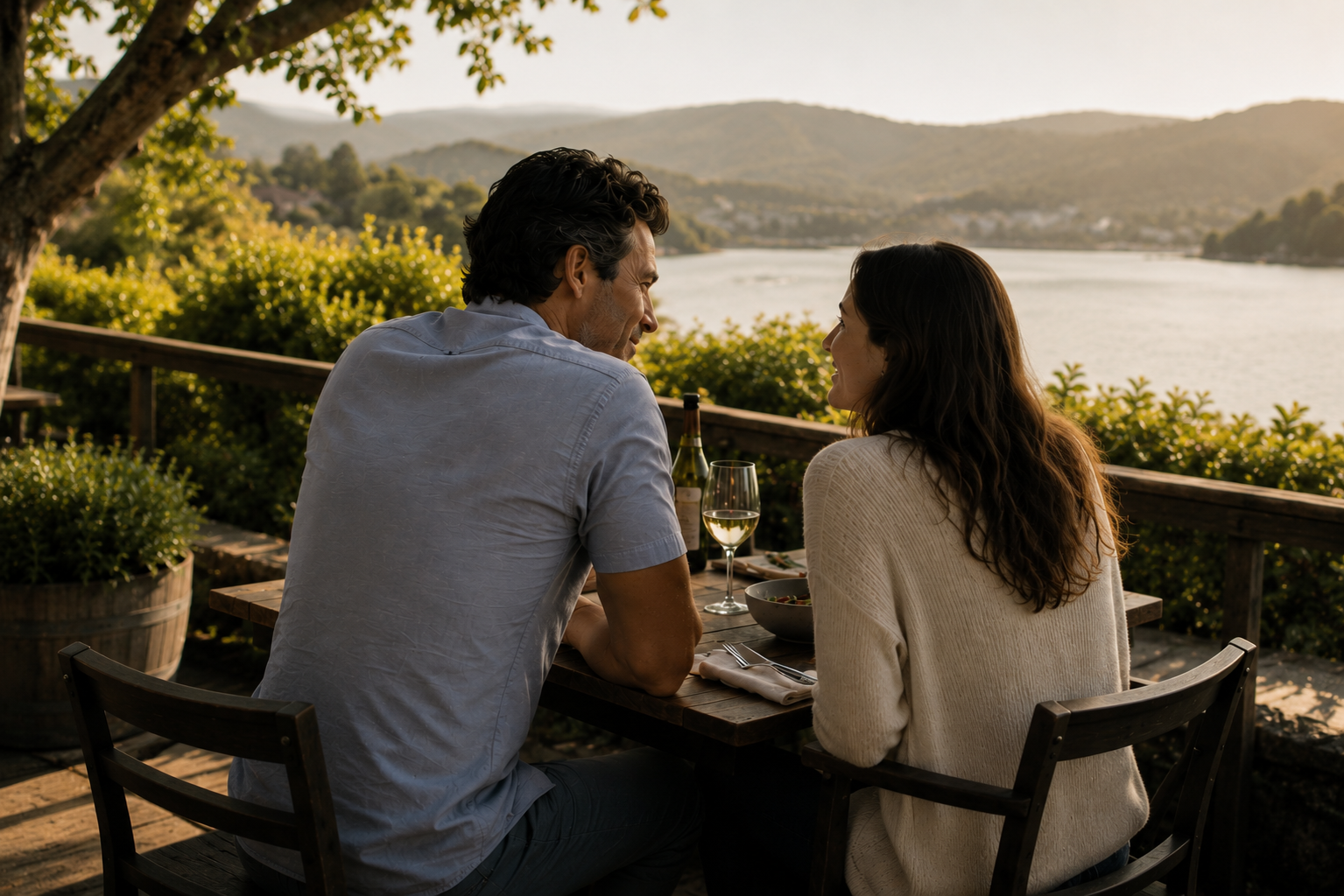 A couple rediscoverig their connection and relationship at an outdoor terrace overlooking a lake.
