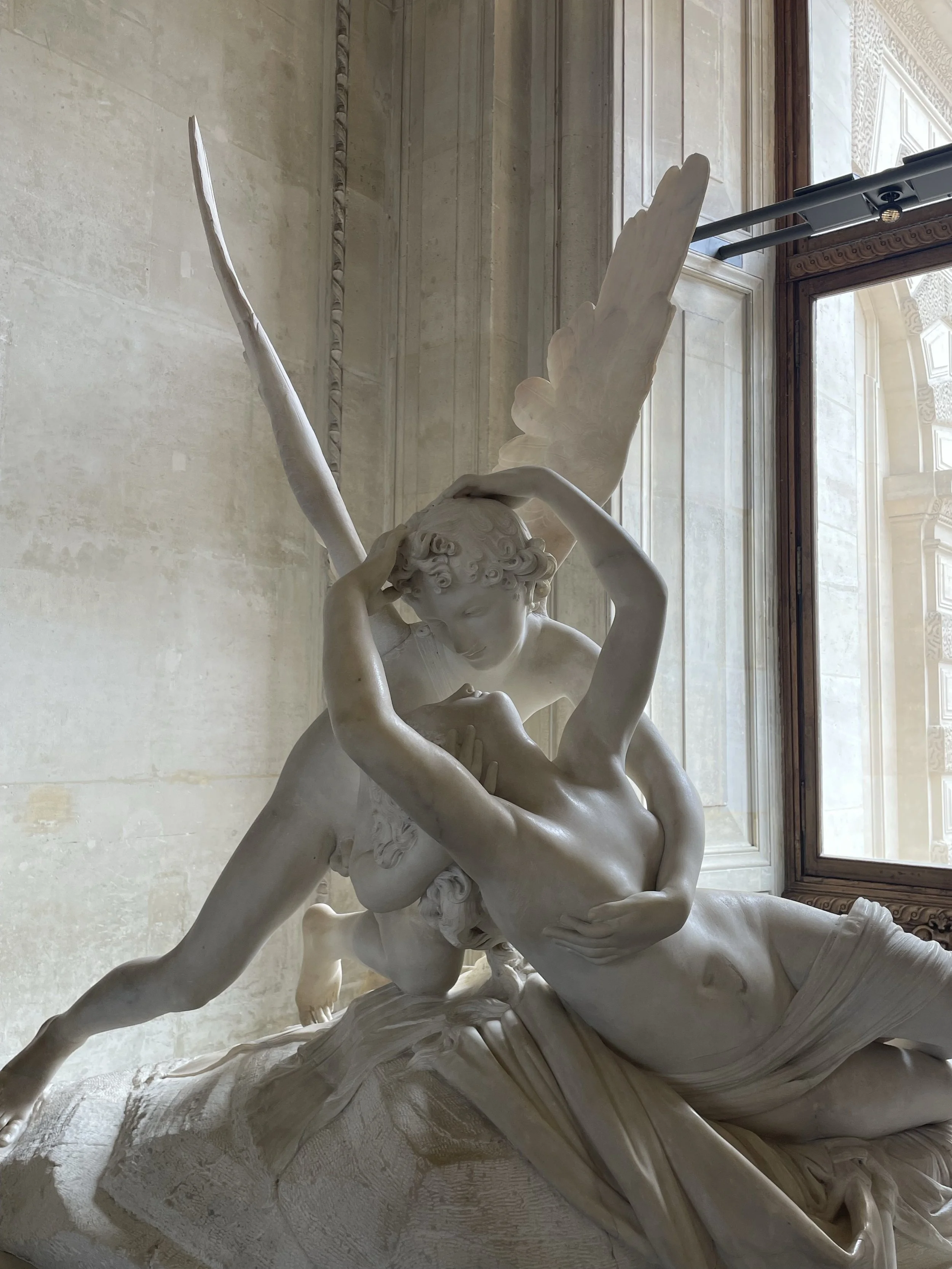 emotional intimacy shown by two white statues in museum