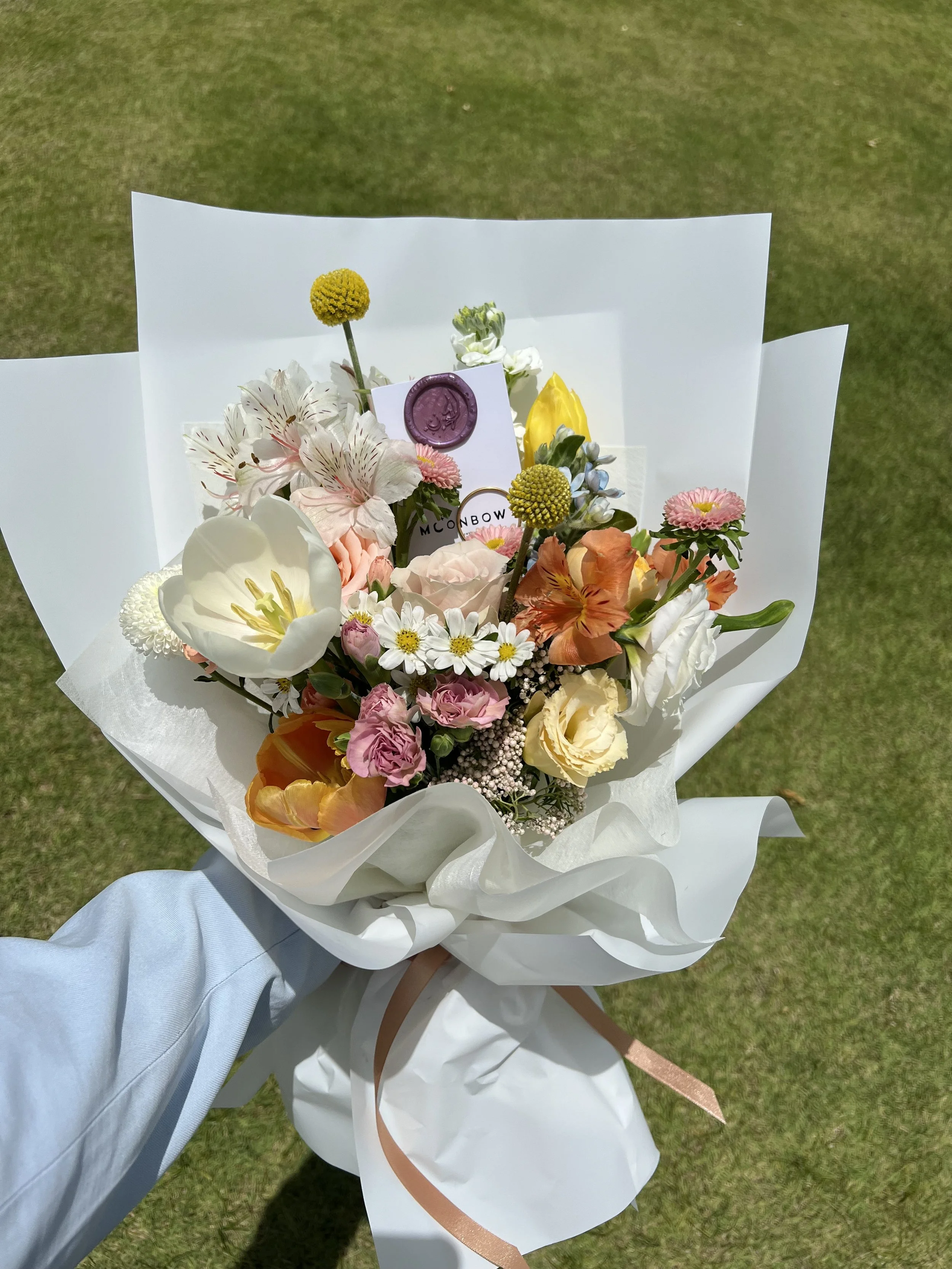 hand holding a bouquet of flowers