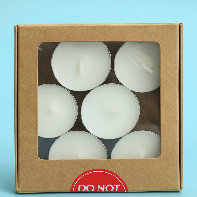 Box of 12 white soy wax tea light candles in silver cups on a blue background