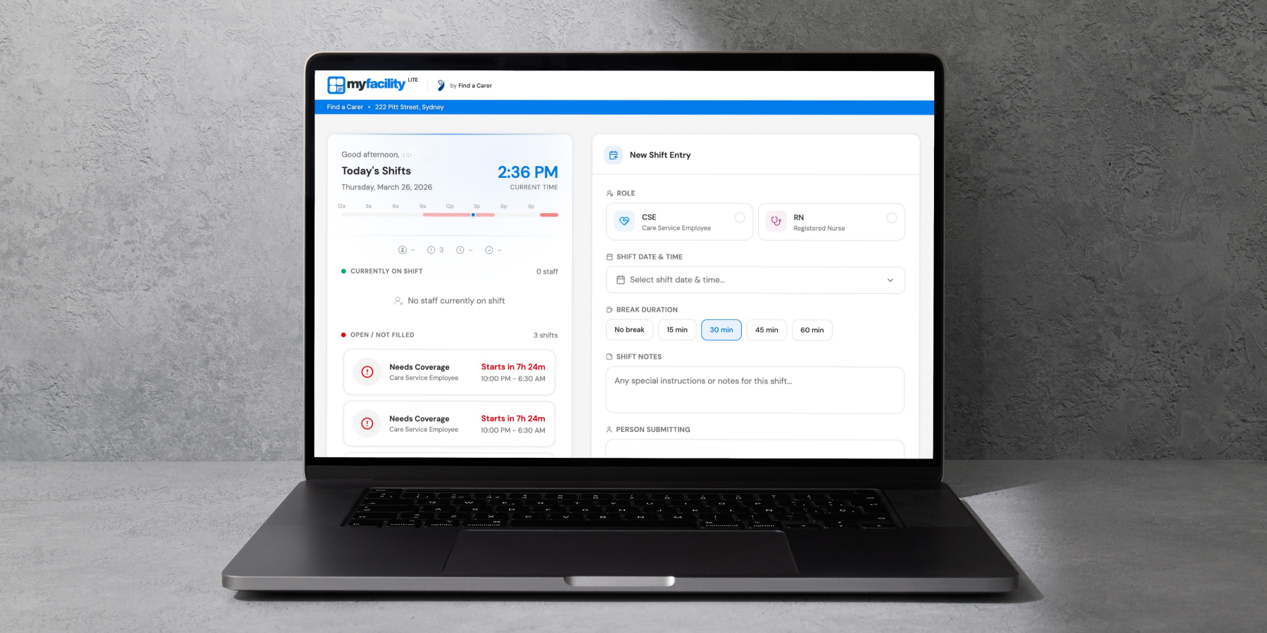 Laptop displaying Find a Carer system for coordinating care workforce. A shift management software with options to select role, shift time, break duration, and notes, on a textured gray surface.
