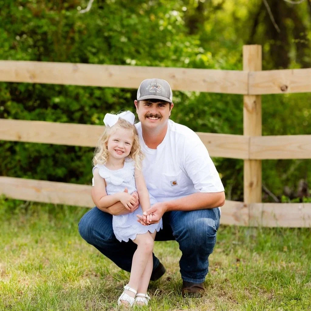 A family portrait session on the outdoor grounds of Sable & Vine