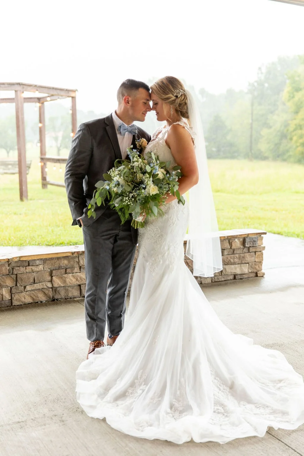 McKenzie and Caleb Porterfield on the patio of Sable and Vine for their wedding day in Stem NC