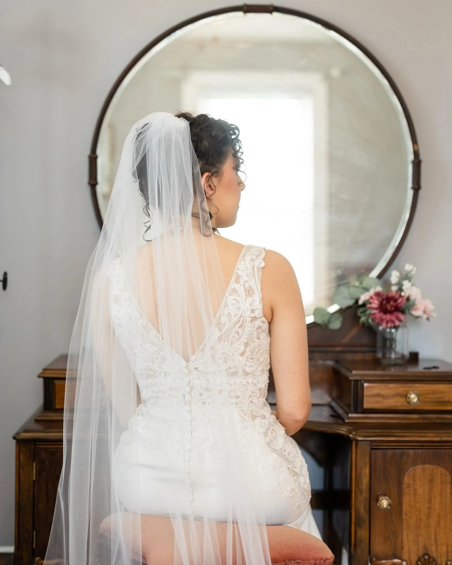 A bride getting ready in the on-site farmhouse accommodations at Sable & Vine