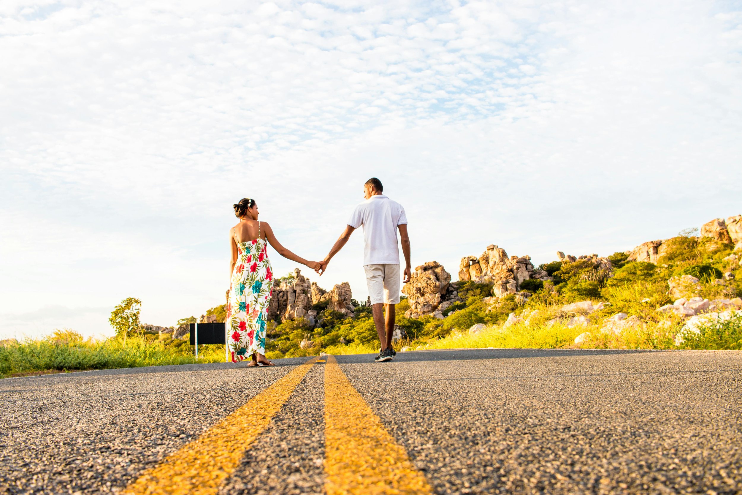 a couple holding hands walking