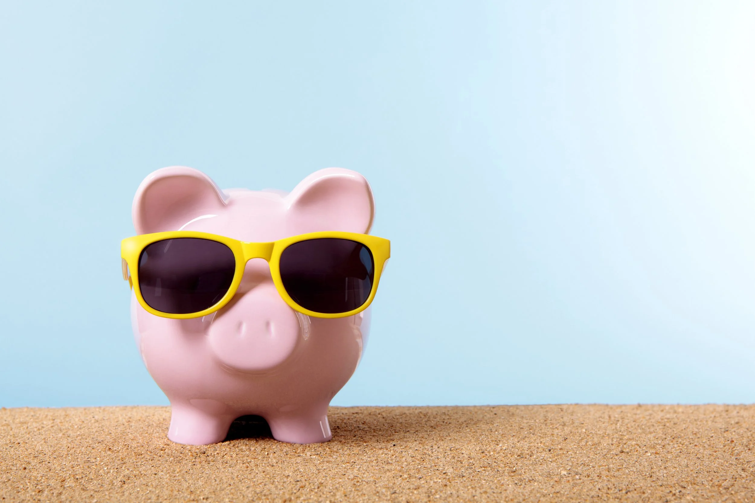 pink piggy bank with yellow sunglasses