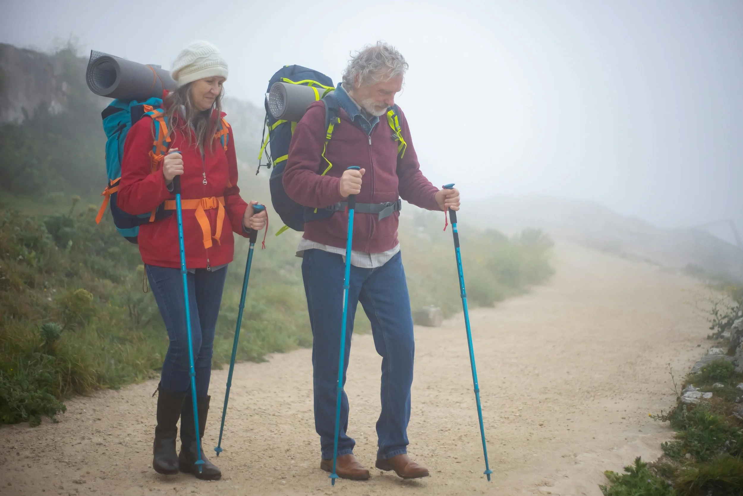 A couple hiking in the mountains the fog
