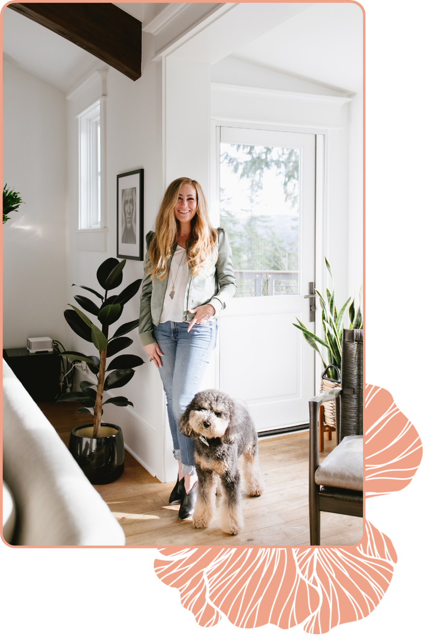Tara Townsend Seattle real estate broker standing in bright modern home with dog, natural light, wood floors, and indoor plant