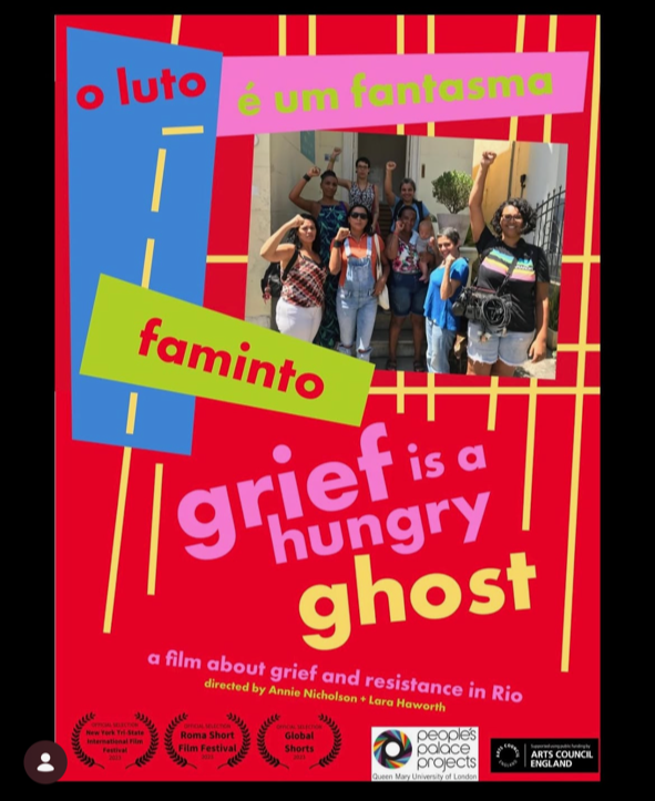 A colorful poster for a film titled 'Grief is a Hungry Ghost,' showing a group of people with raised fists, celebrating or protesting. The poster includes various bright colors, text in both English and Portuguese, and logos of film festivals and organizations.