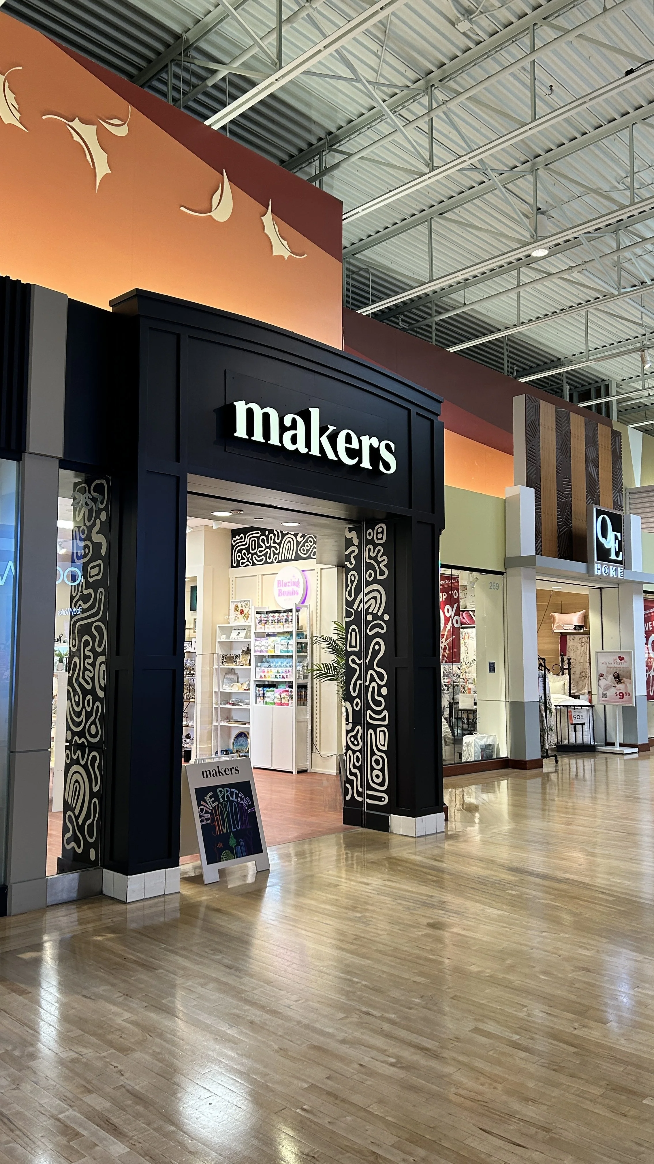 Shop entrance with signage for 'makers' inside a mall.