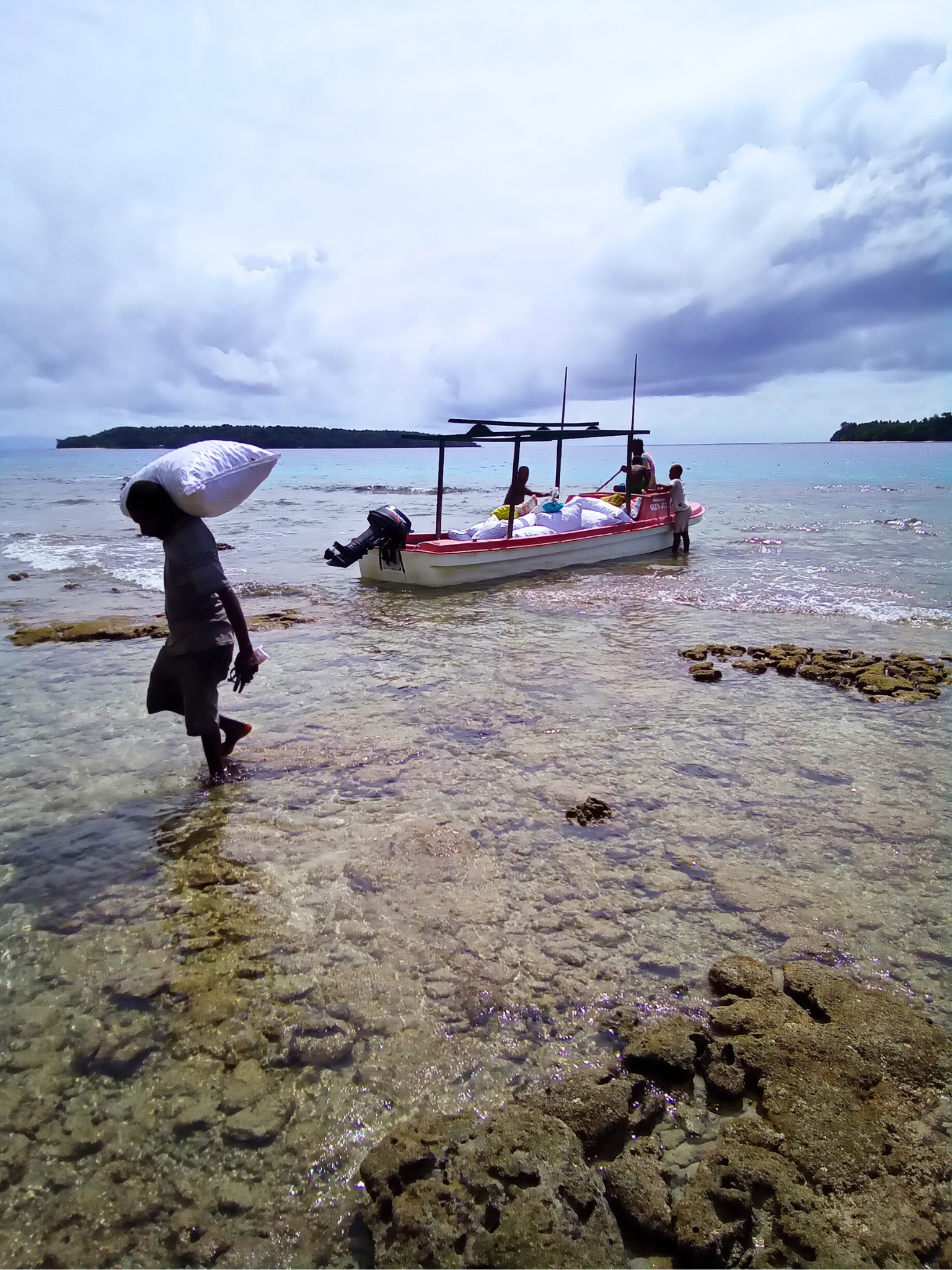 People transporting sacks of tamanu nuts from remote islands in Vanuatu to Port Vila Green Forest Oils headquarters