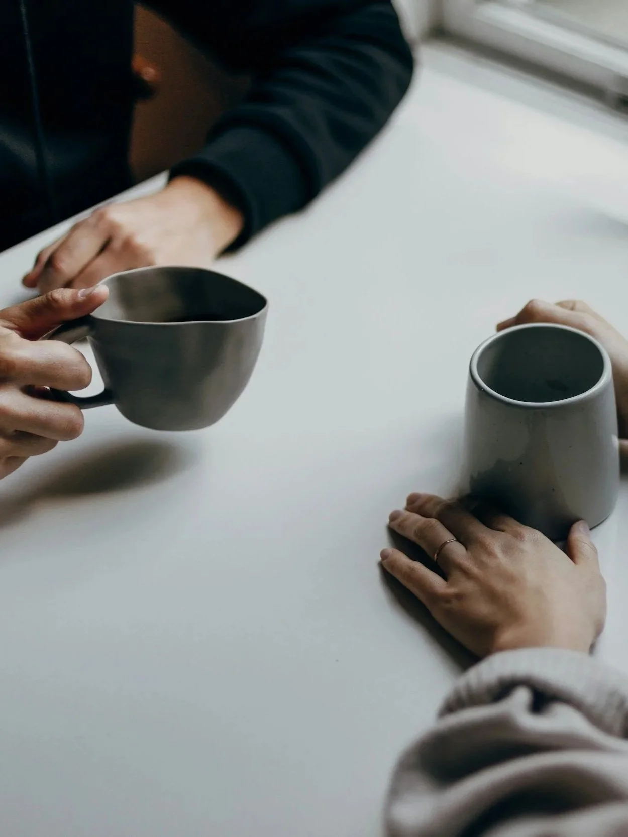 Image of two people having a discussion over coffee.