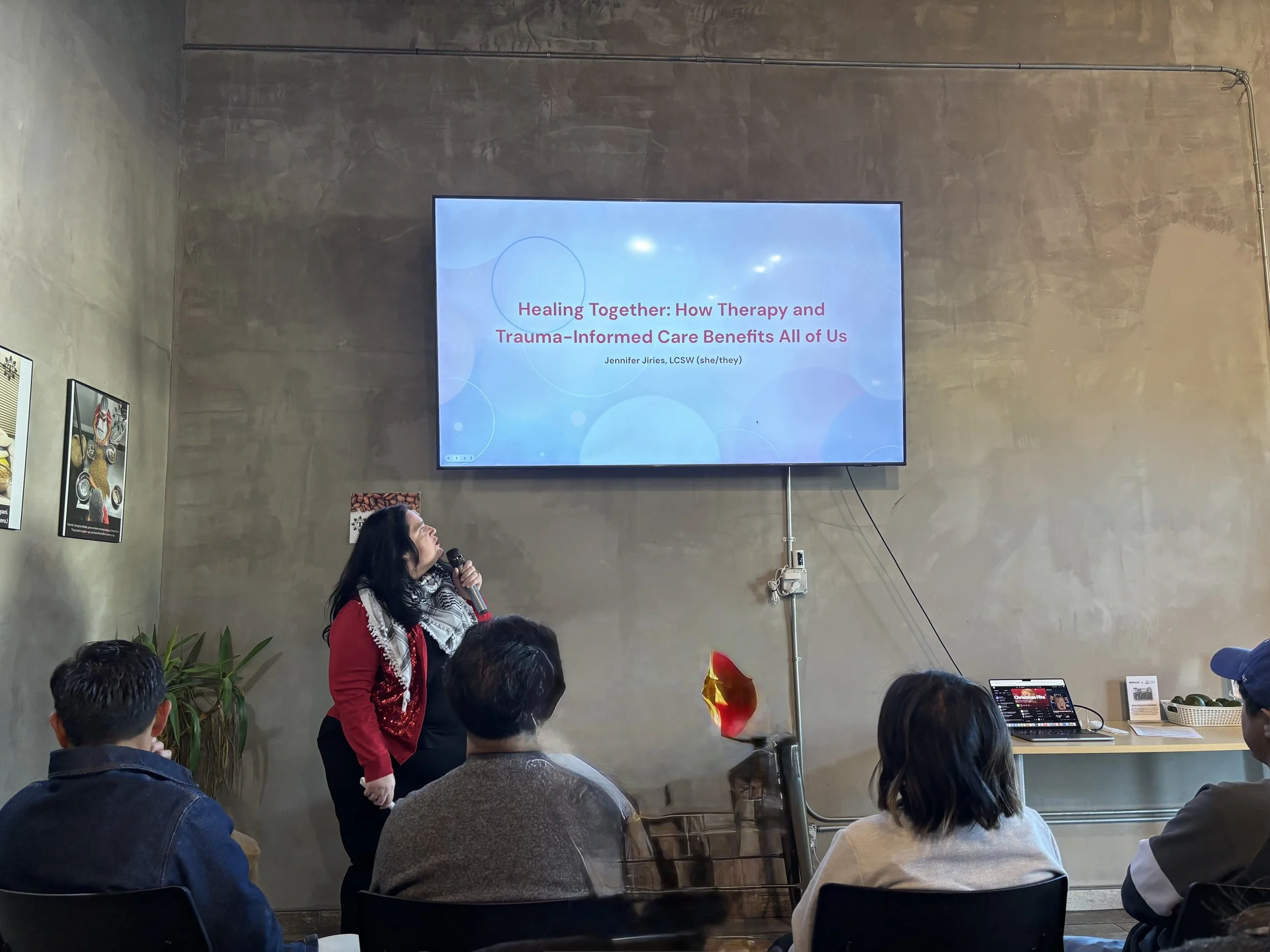 Jennifer giving a presentation on how therapy and trauma-informed care benefits everyone.