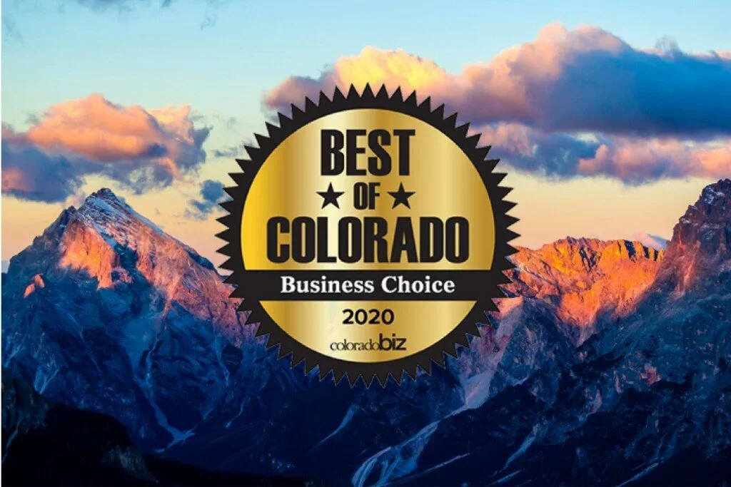 A scenic view of the mountains in Colorado during sunset with a badge in the center that reads "Best of Colorado Business Choice 2020" by colorado.biz.