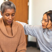 Young woman comforting Older woman