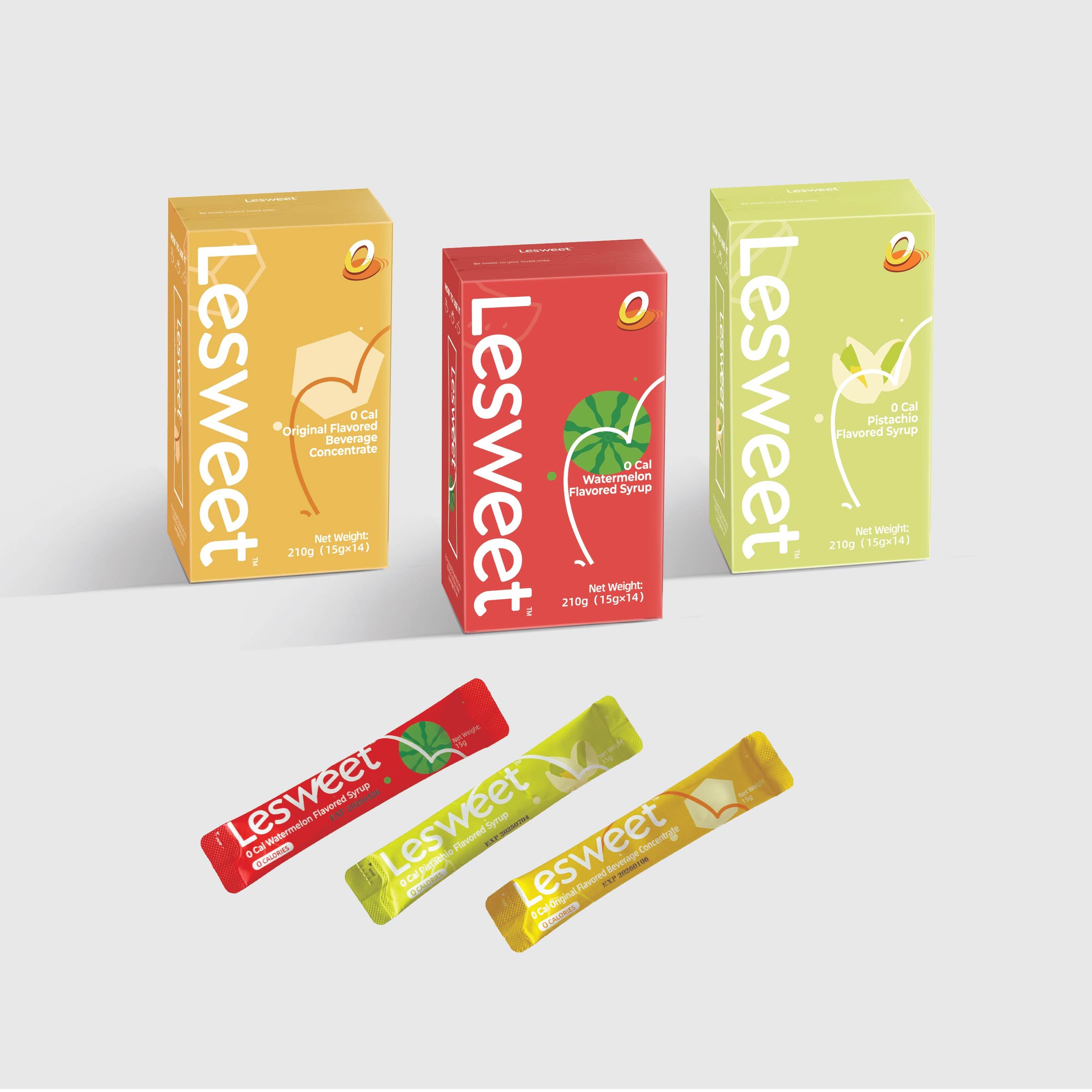 Three boxes of LesSweet flavored syrups in yellow, red, and green, with matching flavor-colored packets below: orange, watermelon, and pistachio.