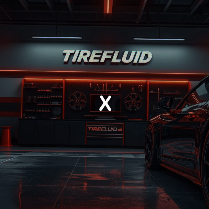 A garage with a wall-mounted sign that reads 'TIREFLUID' and a workbench with wheel rims, tools, and a TV screen. Part of a black car is visible on the right side.