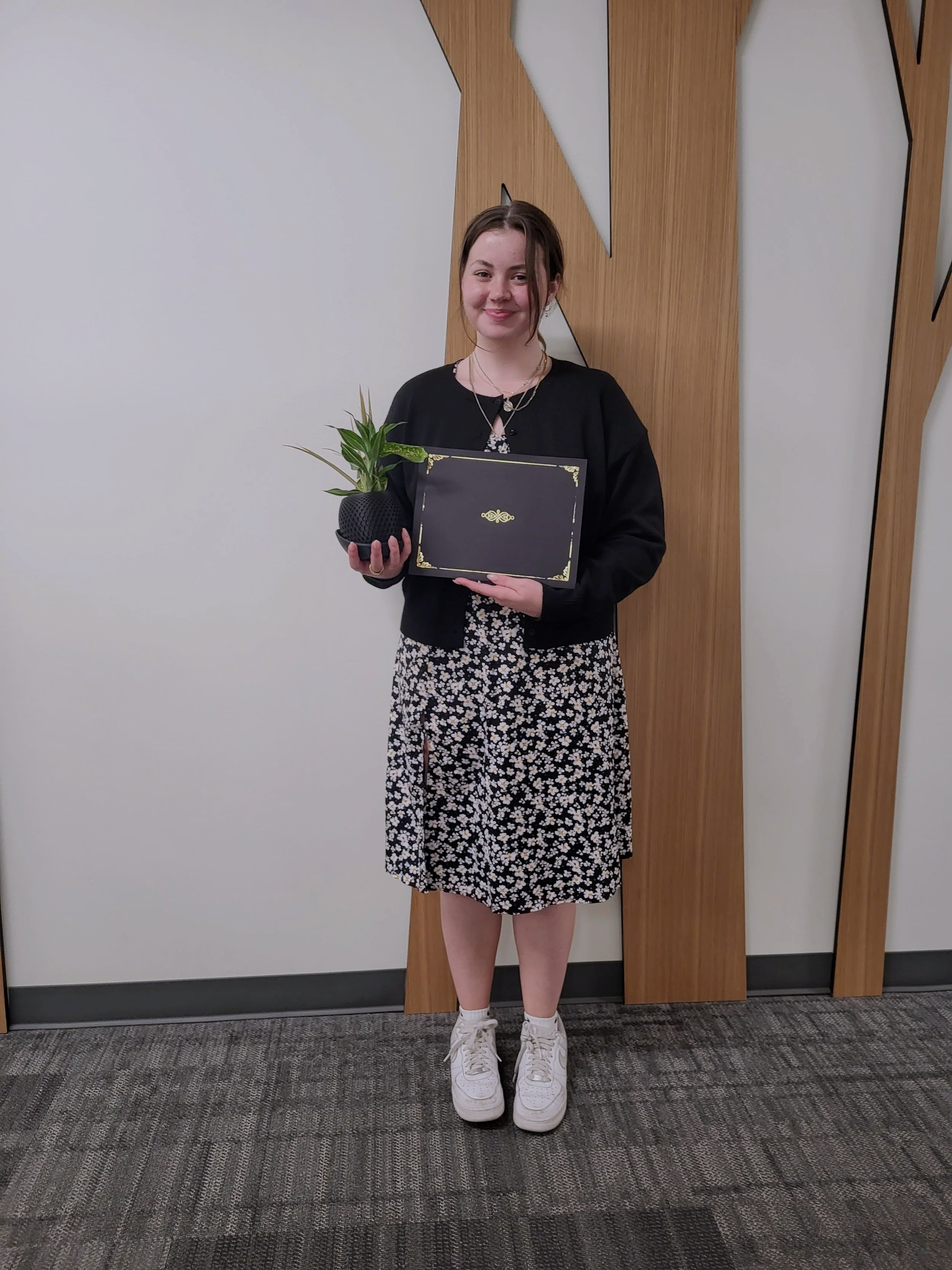 Amanda Lowry Wiberg holding an academic award