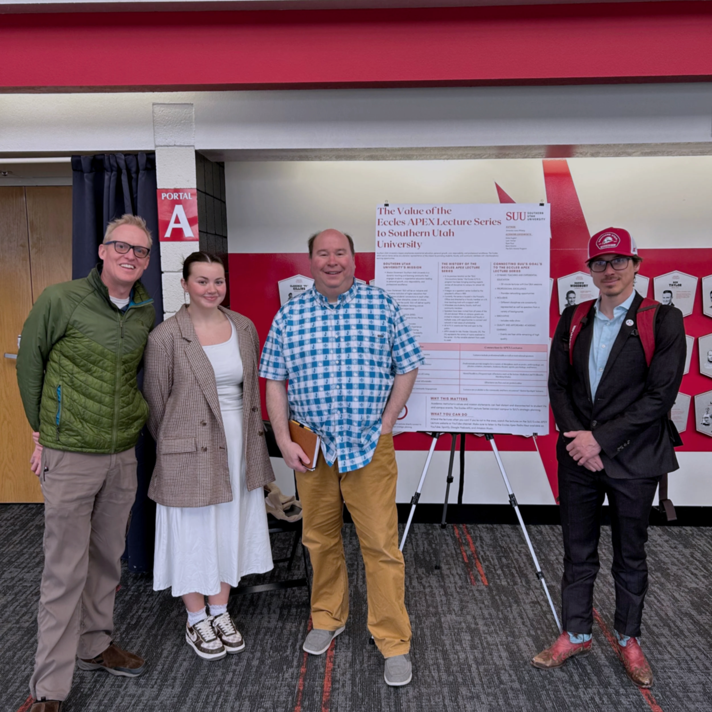 Amanda Lowry Wiberg and three other professors standing in front of an academic poster