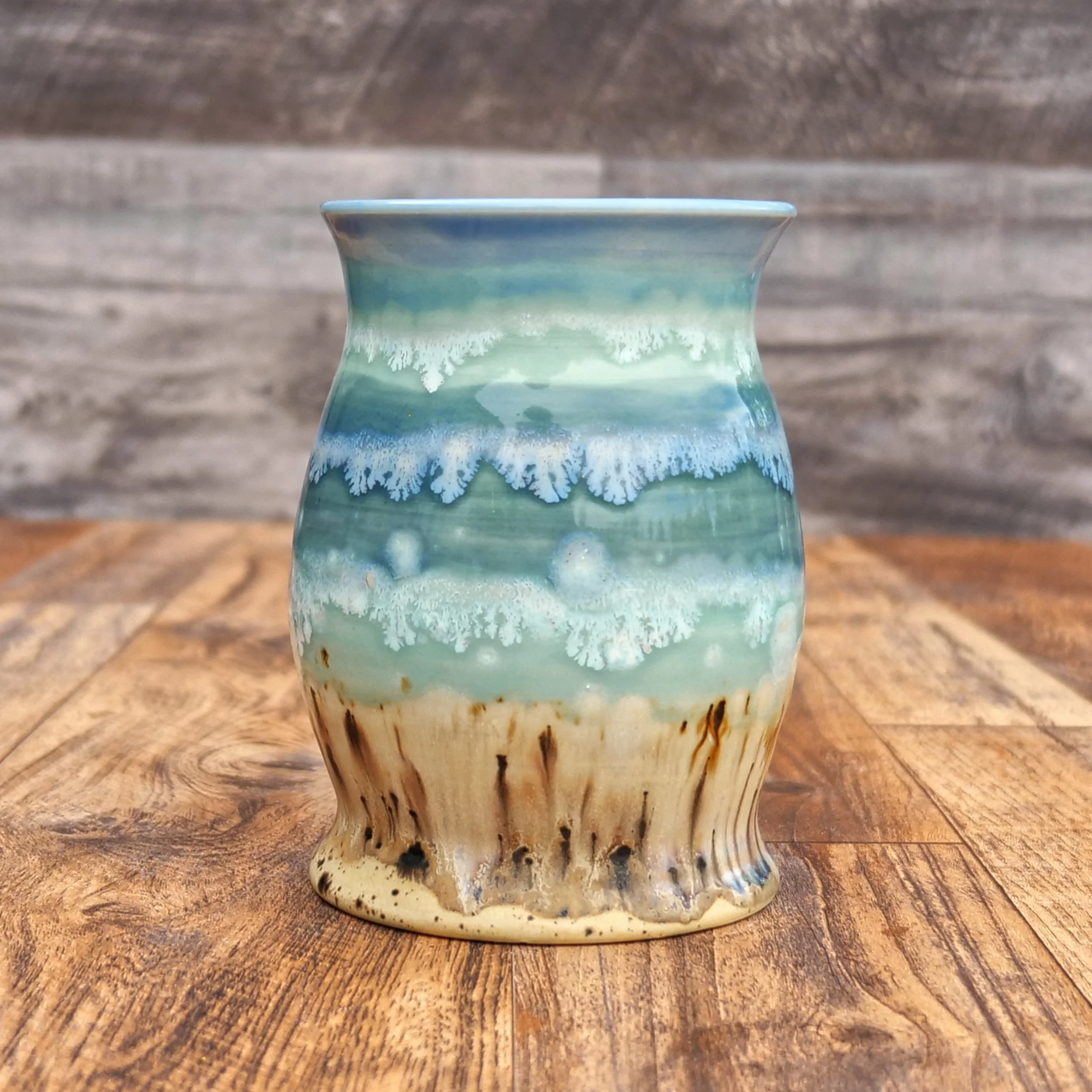 Handmade Tidewater Mug by Elderkiln Ceramics featuring layered coastal blue, seafoam, and sandy stoneware glazes with flowing organic textures.