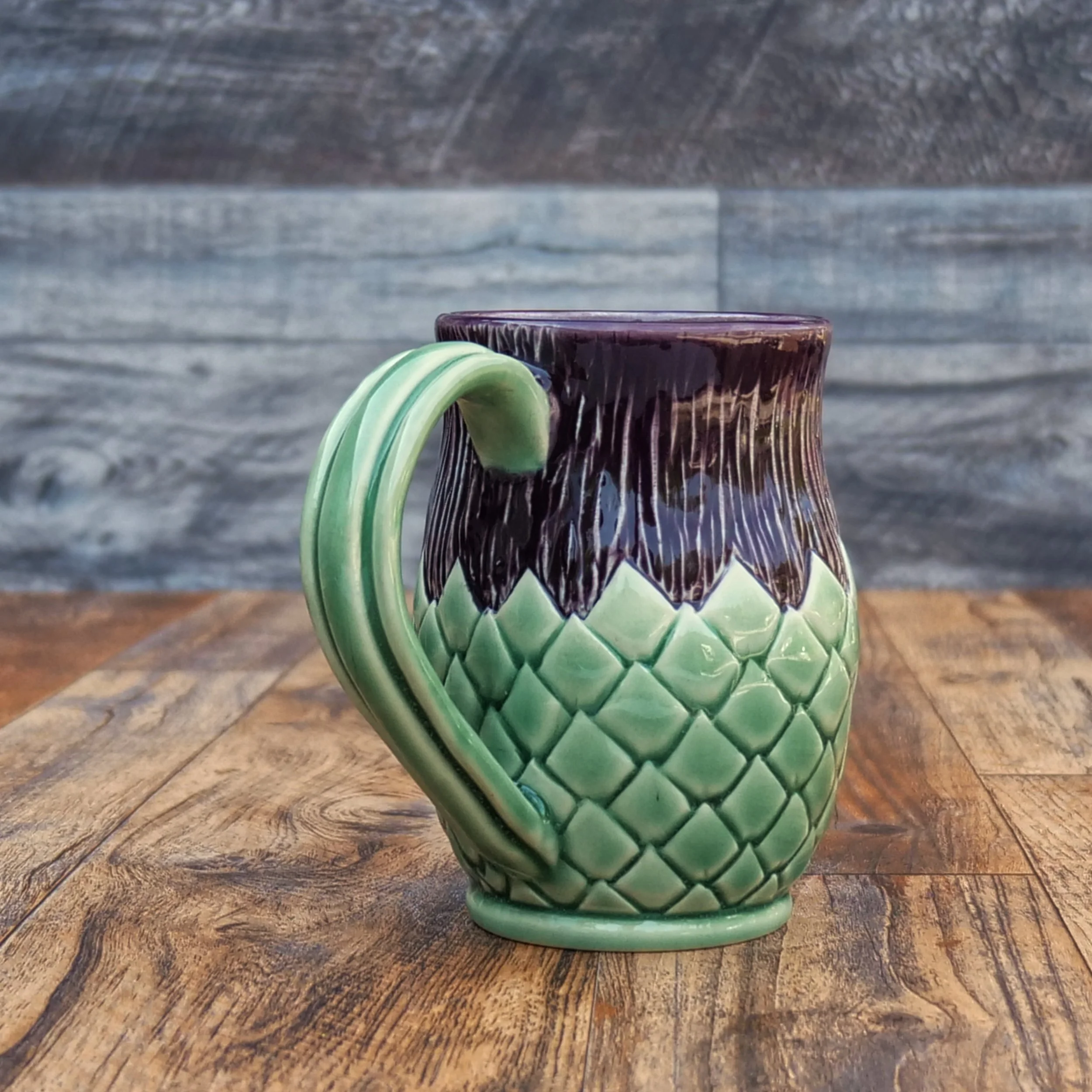 Handmade Highland Thistle Mug by Elderkiln Ceramics featuring sculpted thistle-inspired textures and layered purple and green stoneware glazes.